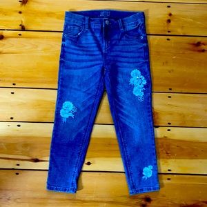 Blue jeans with flowers on them